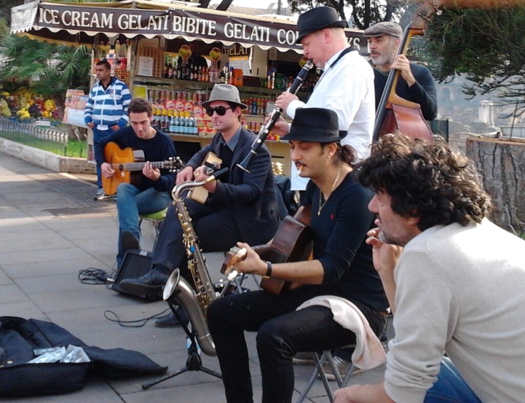 With my friends Simone Magliozzi, Miraldo Vidale, and others, busking outside the Colosseum in Rome.